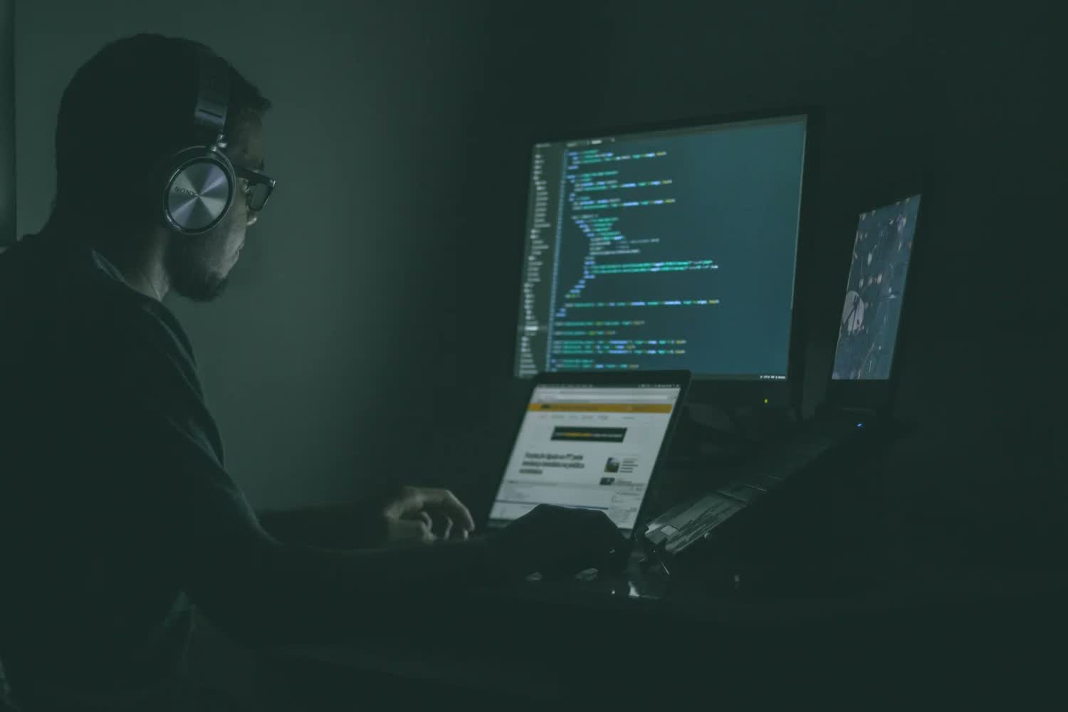 Analyst working at a screen in a darkened room